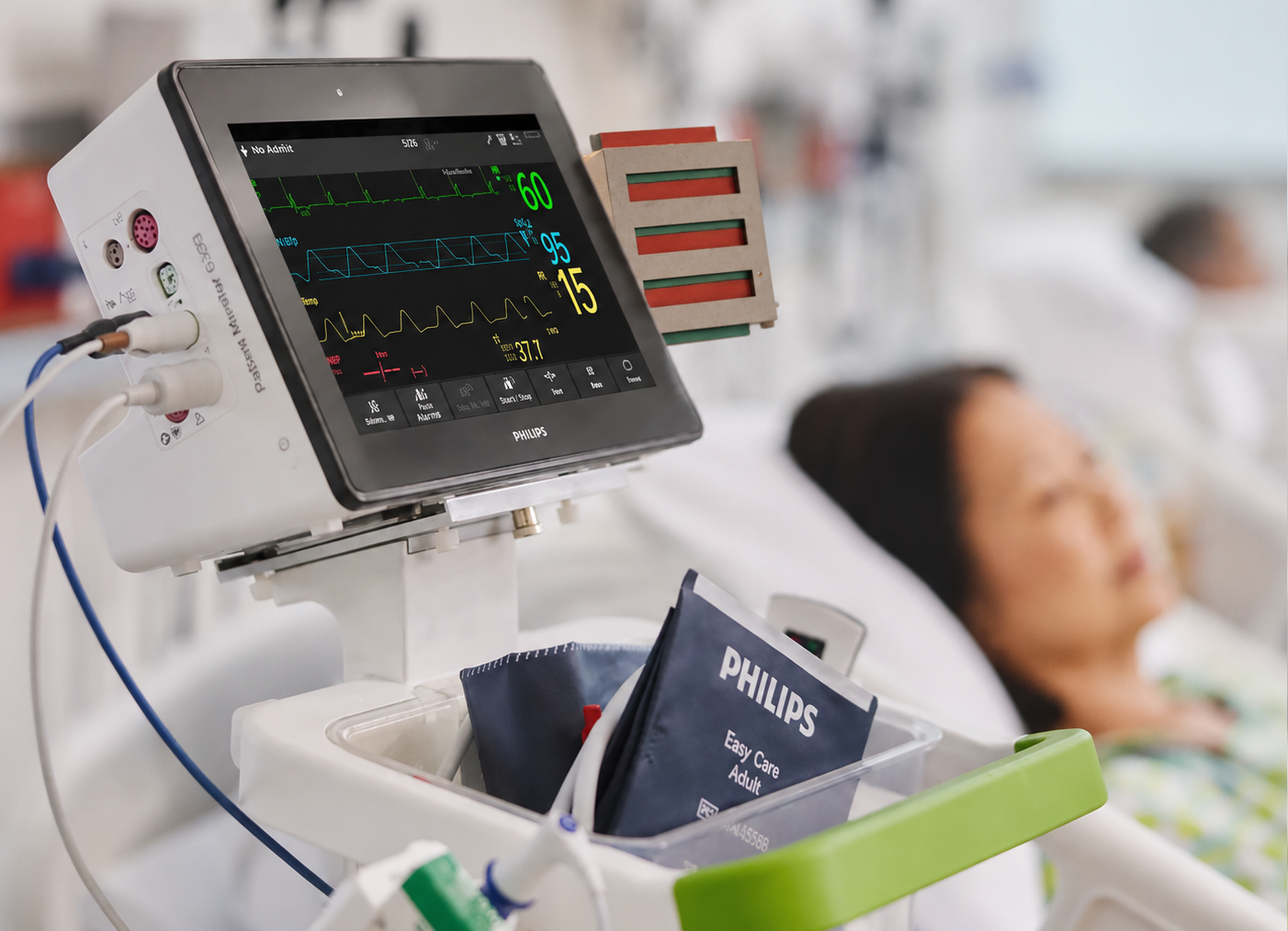 A physical side-bed reminder card mounted on a Philips bedside monitor at the point of care.